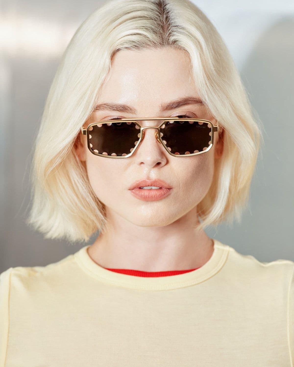 Caspian sunglasses in gold/black, worn by a model in editorial lifestyle photo