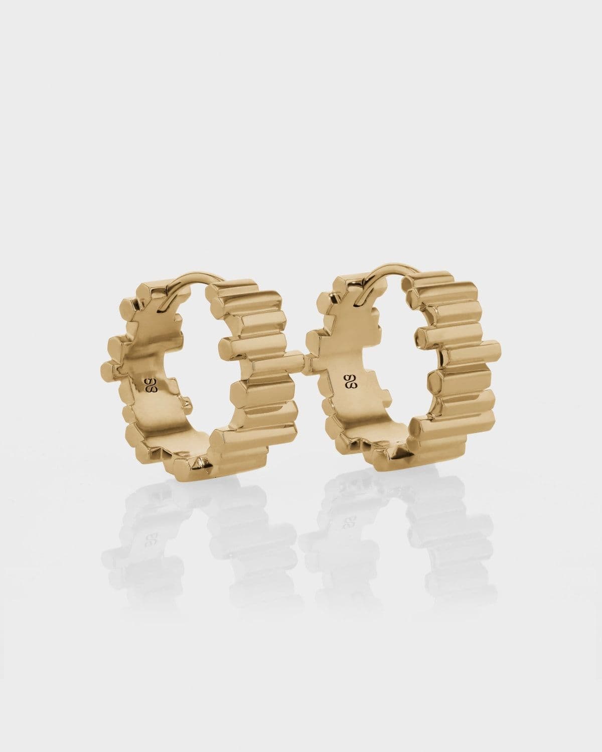 Model wearing yellow gold Pillar Hoops earrings, lifestyle photography